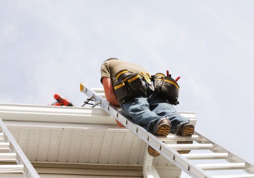A man cleaning gutters in East Peoria IL